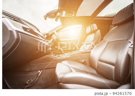 Car inside. Interior of prestige modern car. Comfortable leather seats. Black cockpit with on isolated white background. Car inside. Interior of prestige modern car. Comfortable leather seats. Black cockpit with on isolated white background. 94261570