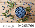Fresh blueberries in bowl on wooden planks 94263769