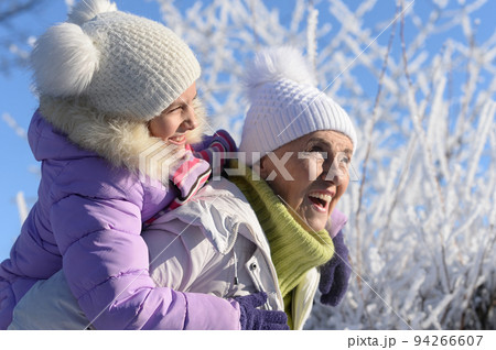 Beautiful elderly woman and her granddaughter enjoy winter Beautiful elderly woman and her granddaughter enjoy winter 94266607