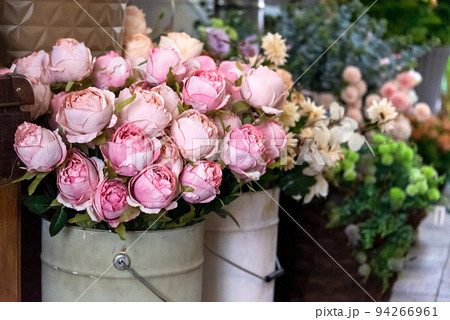 Pink peonies in bucket vases in flower shop. Spring flowers, vintage metal vases with bouquets for sale. Pink peonies in bucket vases in flower shop. Spring flowers, vintage metal vases with bouquets for sale. 94266961