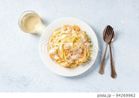 Italian seafood pasta. Pappardelle with shrimps and cream sauce, overhead shot 94269962