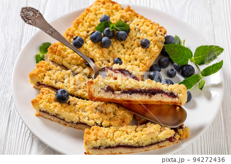 sliced blueberry crumble pie on plate, top view 94272436