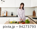 Young pretty woman preparing food in new modern kitchen 94273793
