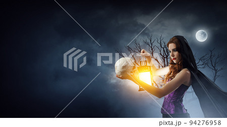 Beautiful young woman in witches hat and costume 94276958