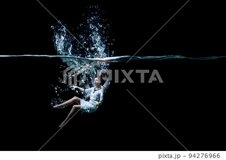 Young businesswoman swimming underwater . Mixed media 94276966