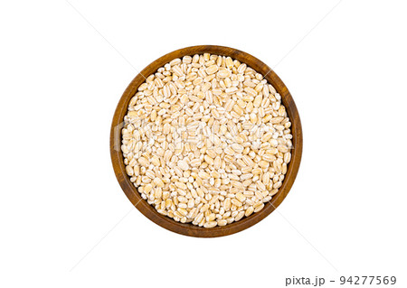 Top view or flat lay of fresh raw barley in wooden bowl. Top view or flat lay of fresh raw barley in wooden bowl. 94277569