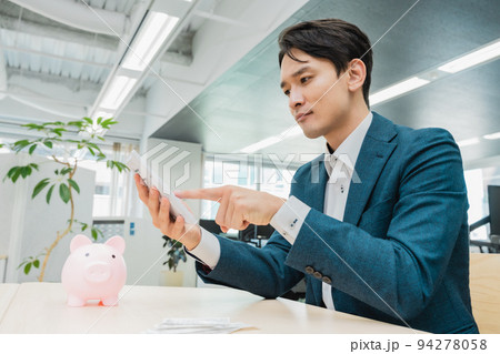お金の計算をするビジネスマン 94278058