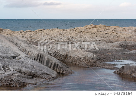 coastal seascape with beautiful columnar basalt rocks at low tide coastal seascape with beautiful columnar basalt rocks at low tide 94278164