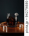 An ice cube thrown into a glass creates a wave of interesting shape. A chilled alcoholic cocktail at the bar will create a good mood for you. 94279880