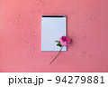 The white sheets of the notebook will be the perfect background for writing your advertising text. Silver sequins are scattered around on a pink table. 94279881