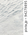 The place of transition from smooth snow cover to light snow ripples created by the wind. Shiny snowflakes add frostiness. 94279895