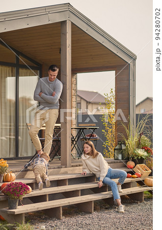 Happy parents spending time with their son outdoors 94280702