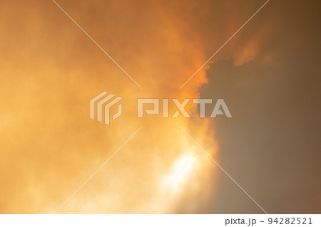 Cloud of smoke from large forest fire passing in front of sun. Cloud of smoke from large forest fire passing in front of sun. 94282521