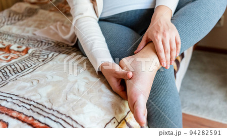 Pregnancy pain leg woman. Pregnant girl have leg disease, ankle pain doing health massage exercise. Foot swelling during pregnancy. 94282591