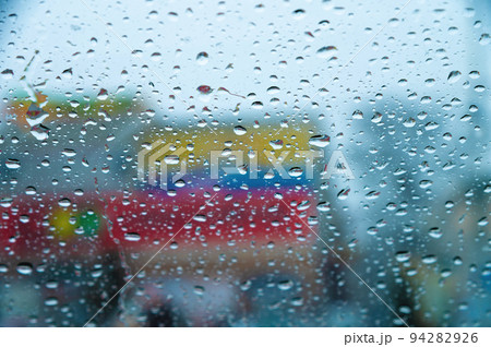 Focus on rain drops, indoor photography, blurred background. Seasonal rain, abstract Focus on rain drops, indoor photography, blurred background. Seasonal rain, abstract 94282926