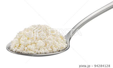 Cottage cheese in spoon isolated on white background 94284128