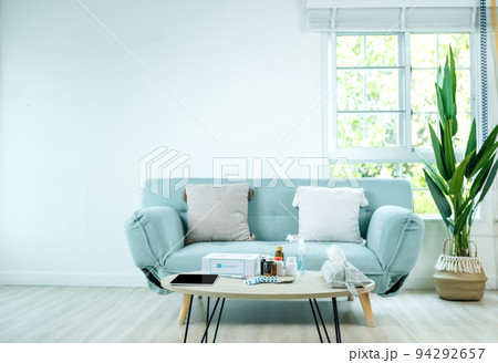 First aid kit box delivery service from hospital and table placed on table in front of blue fabric sofa. 94292657