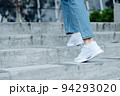 Close up white shoes of woman walking on staire in the outdoor park in sunny day 94293020