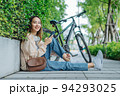 Beautiful Asian woman happiness holding umbrella and listening favourite music on headphones from mobile phone, Happiness relaxation summer in park with music 94293025