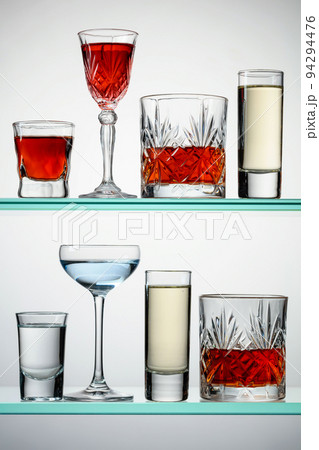 Various alcoholic drinks on glass shelves. Various alcoholic drinks on glass shelves. 94294476