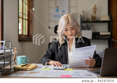 Happy smiling young asian entrepreneur woman counting profit, on calculator at laptop computer, analyzing benefits, enjoying financial success, job high result. Happy smiling young asian entrepreneur woman counting profit, on calculator at laptop computer, analyzing benefits, enjoying financial success, job high result. 94297659