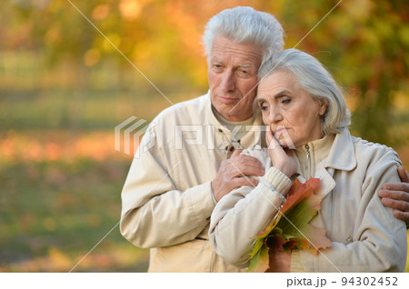 Portrait of a sad seniors in autumn park Portrait of a sad seniors in autumn park 94302452