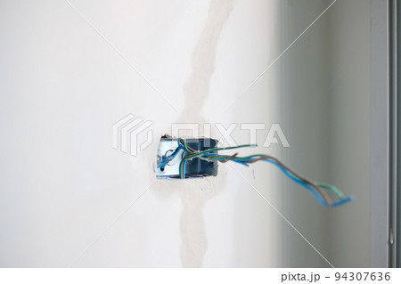 Electrical Wiring under plaster, hidden installation cables for socket to a concrete. Renovation, Repair and development of home and apartment concepts 94307636