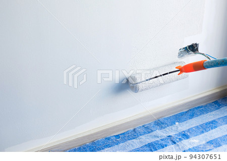painter man with paint roller brush painting the wall. Renovation, maintenance and development of home or apartment painter man with paint roller brush painting the wall. Renovation, maintenance and development of home or apartment 94307651