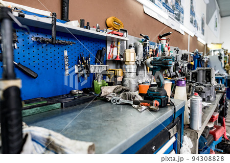 Large workbench with tools at station for vehicle technical servicing 94308828