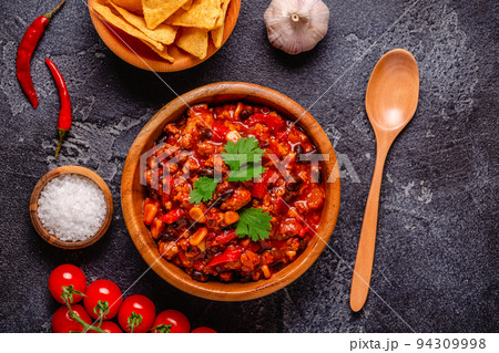 Chili Con Carne in bowl on dark background. 94309998