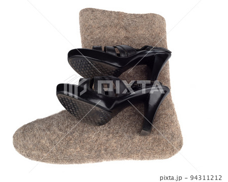 A pair of summer women's shoes on felt boots over a white background. A pair of summer women's shoes on felt boots over a white background. 94311212