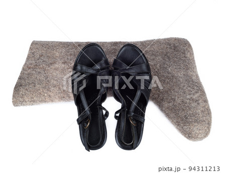 Summer women's shoes and felt boots on a white background. Summer women's shoes and felt boots on a white background. 94311213