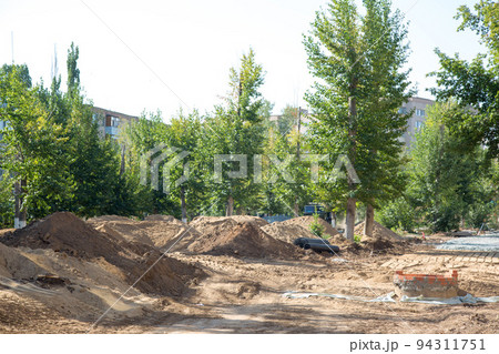 A large mountain of sand in the center of the city brought to repair the road A large mountain of sand in the center of the city brought to repair the road 94311751