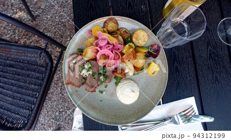 A plate of roast beef with vegetables just cooked. 94312199