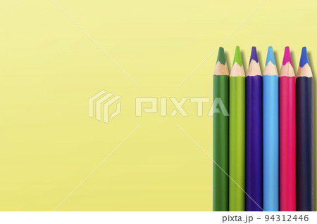 colored pencils on a yellow background colored pencils on a yellow background 94312446