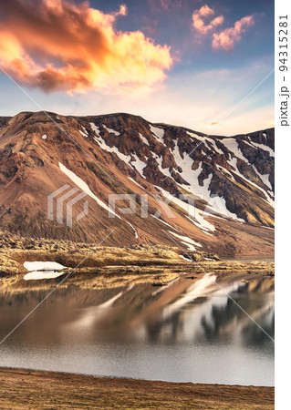 Volcanic mountain range with snow covered and sunset sky in Icelandic highlands on Landmannalaugar at Iceland 94315281