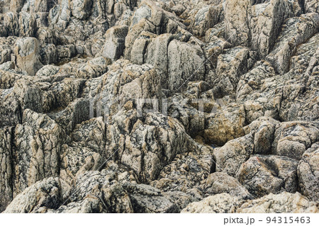 natural stone background, the remains of lava basalt columns form a relief surface natural stone background, the remains of lava basalt columns form a relief surface 94315463
