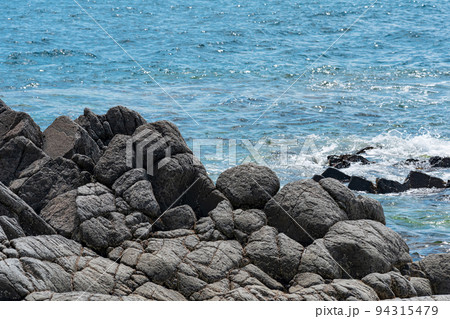 rocky seashore, gray basalt cliffs on the shore 94315479