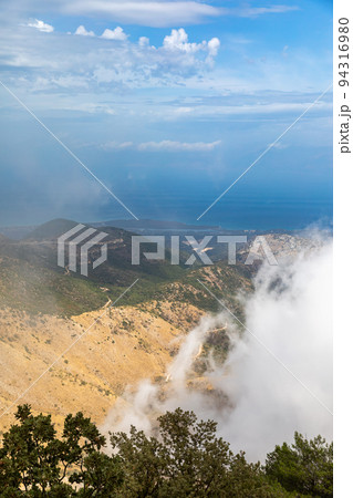 Landscape in the clouds under Mount Pantokrator on the island of Corfu Landscape in the clouds under Mount Pantokrator on the island of Corfu 94316980