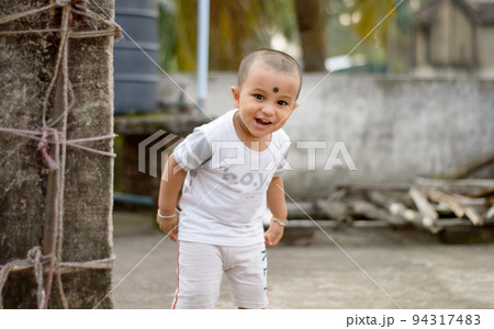 Cute smart naughty baby making a funny and looking at camera. Happy baby background. Cute smart naughty baby making a funny and looking at camera. Happy baby background. 94317483