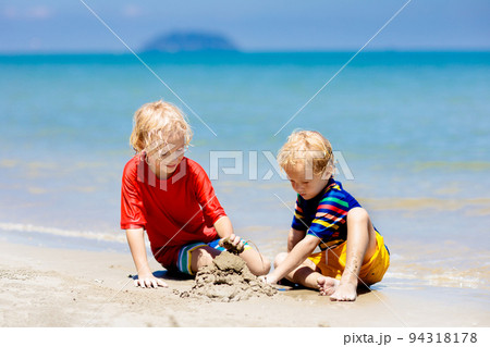 Kids playing on beach. Children play at sea. 94318178