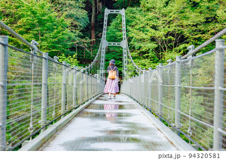 吊り橋を渡る女性・天龍峡の吊り橋(つつじ橋） 94320581