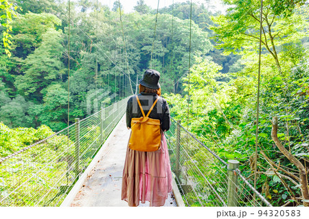 吊り橋を渡る女性・天龍峡の吊り橋(つつじ橋） 94320583