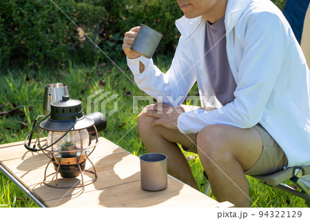 屋外でコーヒーを飲む男性の様子 屋外でコーヒーを飲む男性の様子 94322129