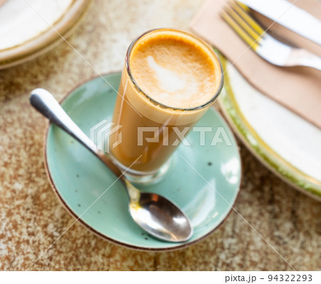 Mug of cortado served on table in cafe 94322293