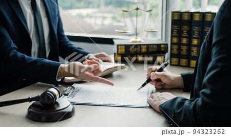 Businesswoman hand sign after Lawyer providing legal consult dispute service at the office with justice scale and gavel hammer 94323262