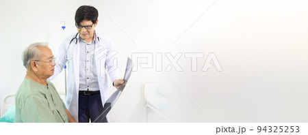 Asian elder adult having a consult with doctor about his disease, doctor explains the x-ray film to Asian senior adult. Health care and wellness in aging society. 94325253