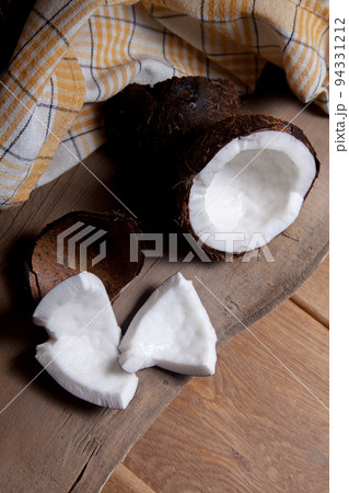 Coconut with white pulp on wooden background.. 94331212