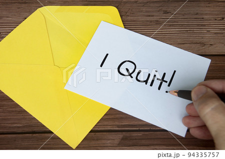 Hand writing I quit text on white notepad with yellow envelope background. Employment concept Hand writing I quit text on white notepad with yellow envelope background. Employment concept 94335757