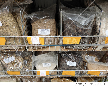 JOHOR, MALAYSIA -AUGUST 6, 2022: Different types of spices are packed, labeled and displayed for sale. Each pack is marked with a price to make it easier for customers. 94336591
